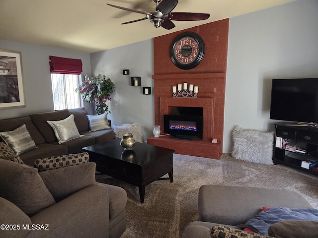 carpeted living area featuring ceiling fan and a large fireplace