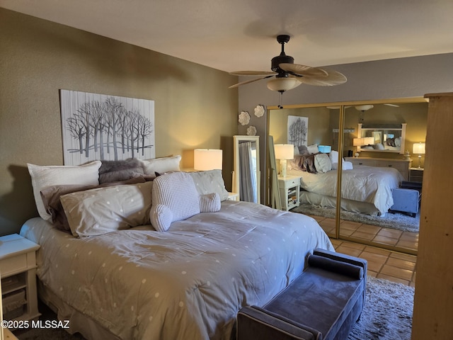 tiled bedroom with a closet and ceiling fan