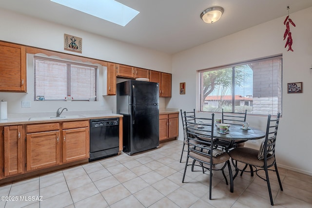 3055 S Placita De La Picaza, Green Valley, AZ 85622 - kitchen featuring black appliances, a skylight, light countertops, and brown cabinets