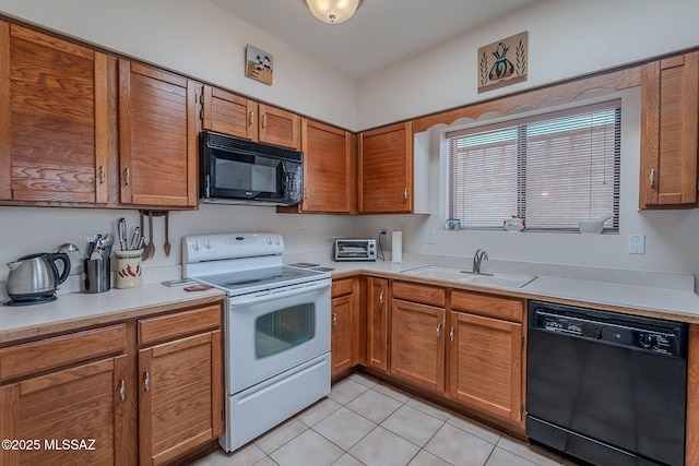 3055 S Placita De La Picaza, Green Valley, AZ 85622 - kitchen featuring black appliances, light tile patterned floors, light countertops, and brown cabinetry
