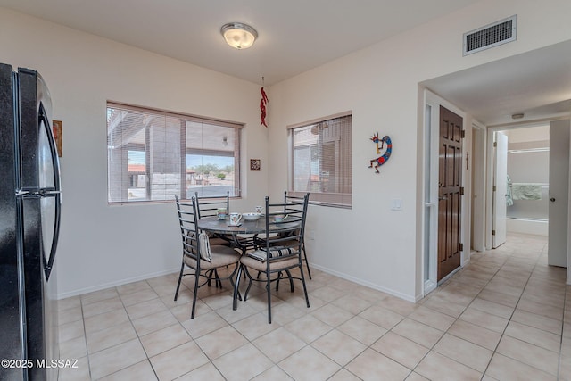 dining space featuring baseboards and visible vents