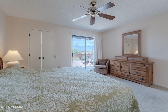 bedroom featuring a closet, a textured ceiling, carpet, ceiling fan, and access to exterior