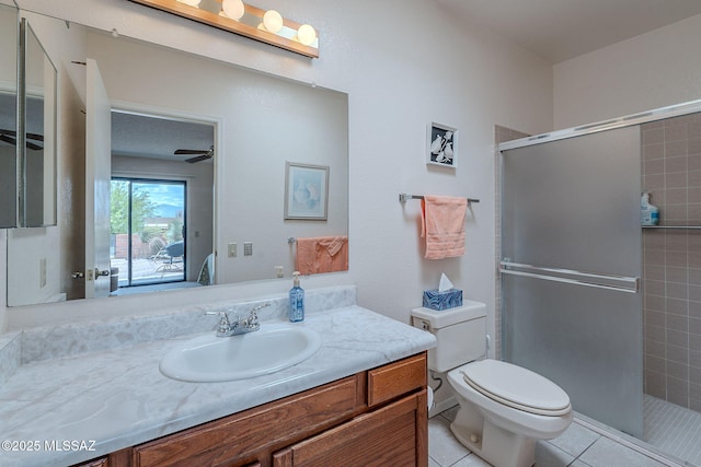 ensuite bathroom with a ceiling fan, toilet, tile patterned flooring, and a tile shower