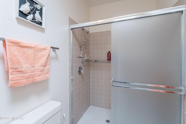 full bath featuring toilet and a stall shower