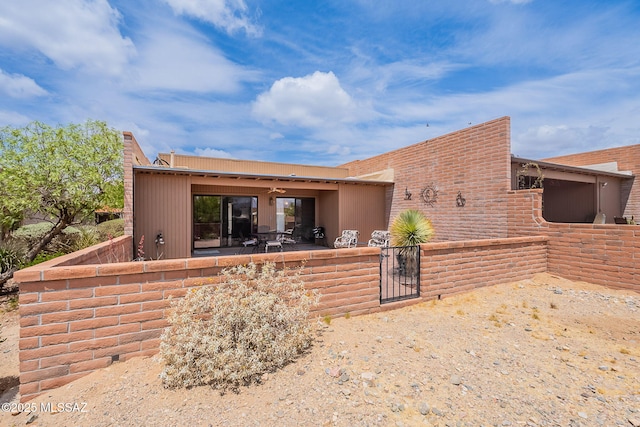 rear view of property with a patio area, a gate, and fence private yard