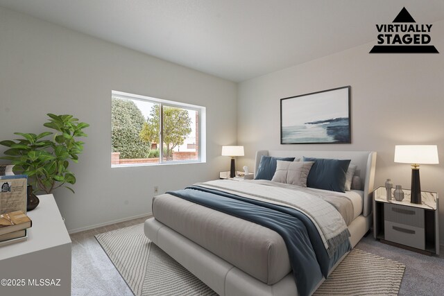 bedroom featuring light carpet and baseboards