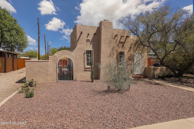 view of front of property with fence and a gate