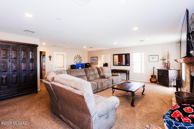 living area featuring carpet floors, visible vents, and recessed lighting
