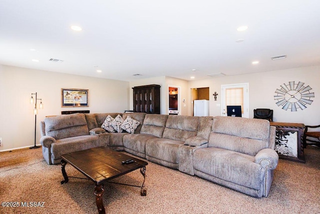 carpeted living room with recessed lighting and visible vents