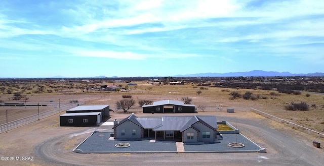 birds eye view of property featuring a rural view, a desert view, and a mountain view