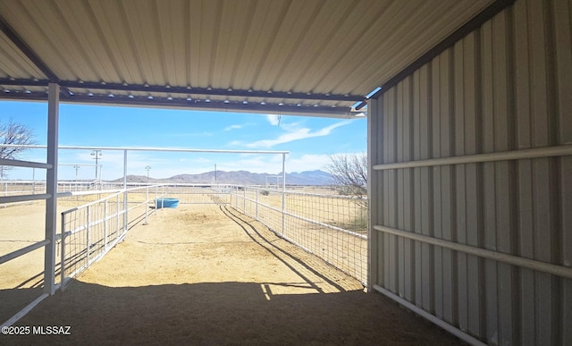 view of yard featuring an exterior structure, an outdoor structure, and a mountain view
