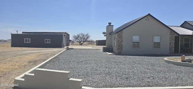 view of side of home featuring stone siding and stucco siding