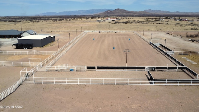 drone / aerial view with a rural view, view of desert, and a mountain view