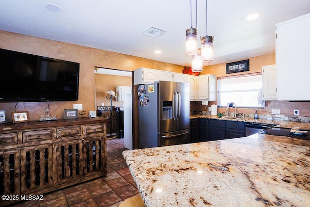 kitchen with white cabinets, a sink, visible vents, light stone counters, and stainless steel fridge with ice dispenser