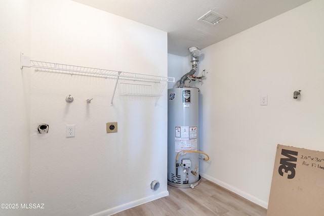 washroom with laundry area, light wood-type flooring, gas water heater, visible vents, and hookup for an electric dryer