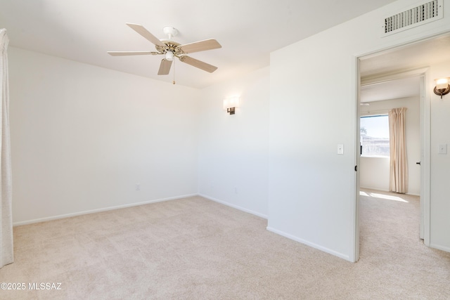 unfurnished room featuring baseboards, a ceiling fan, visible vents, and carpet floors