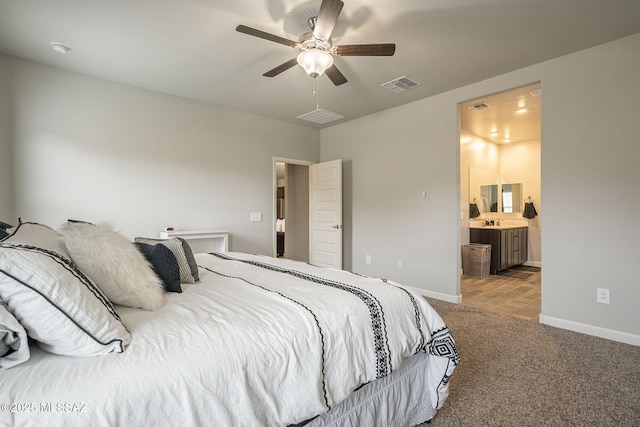 1117 W Valley Meadow Ln, Sahuarita, AZ 85629 - bedroom featuring carpet floors, baseboards, ensuite bathroom, and ceiling fan