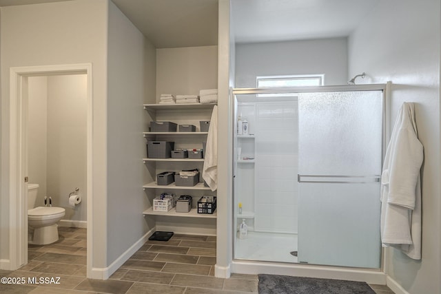 1117 W Valley Meadow Ln, Sahuarita, AZ 85629 - bathroom with a stall shower, toilet, wood tiled floors, and baseboards