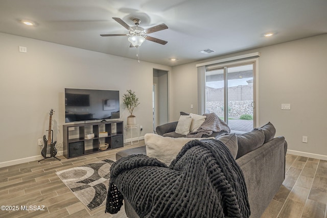 1117 W Valley Meadow Ln, Sahuarita, AZ 85629 - living room featuring light wood-style flooring, baseboards, a ceiling fan, and recessed lighting