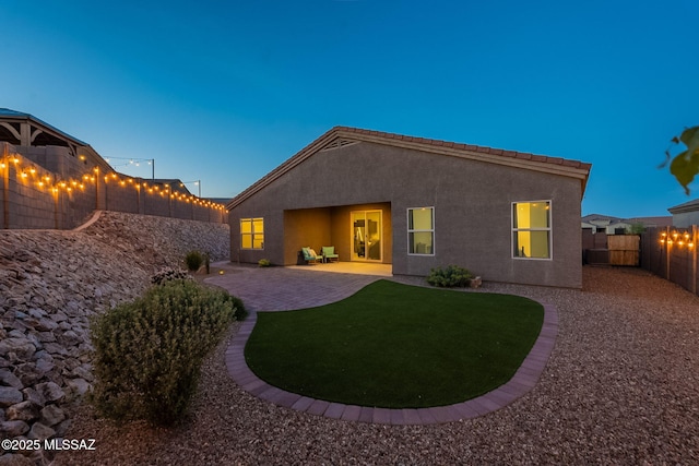 1117 W Valley Meadow Ln, Sahuarita, AZ 85629 - back of property with a patio area, stucco siding, and a fenced backyard