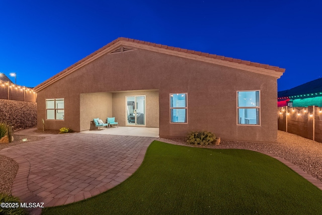 1117 W Valley Meadow Ln, Sahuarita, AZ 85629 - back of house at twilight with a patio area and stucco siding