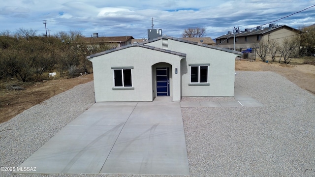 exterior space with a patio area, stucco siding, and a tile roof