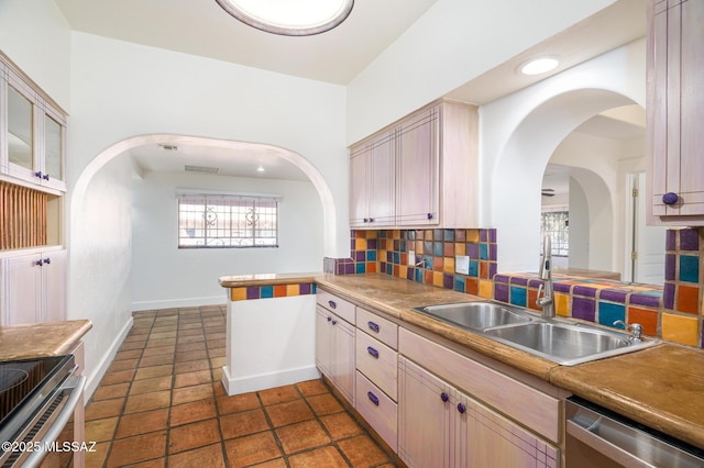 3737 E Pima St, Tucson, AZ 85716 - kitchen with arched walkways, recessed lighting, a sink, stainless steel appliances, and backsplash