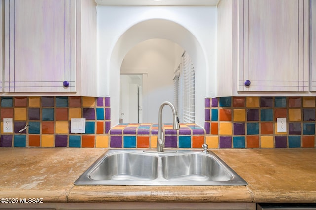 3737 E Pima St, Tucson, AZ 85716 - kitchen featuring arched walkways, dishwasher, a sink, and backsplash
