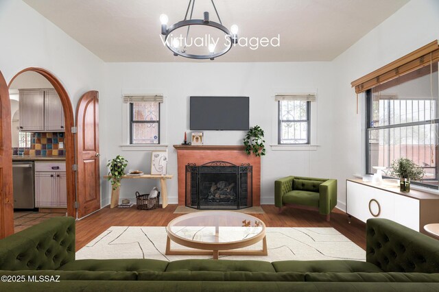 3737 E Pima St, Tucson, AZ 85716 - living area featuring an inviting chandelier, wood finished floors, and a fireplace
