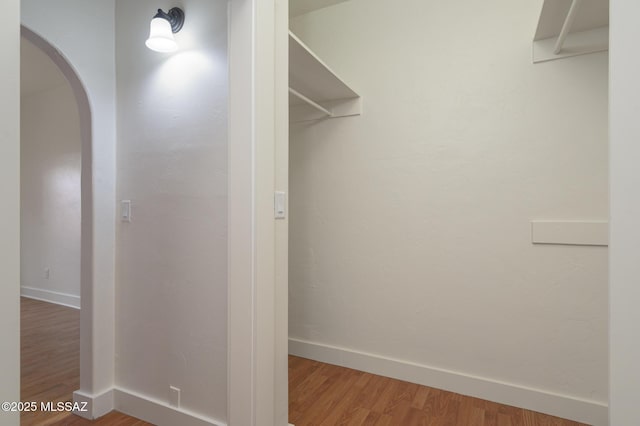 3737 E Pima St, Tucson, AZ 85716 - walk in closet featuring arched walkways and wood finished floors