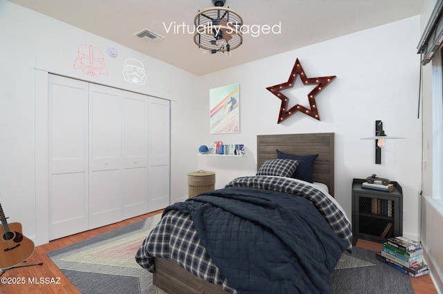 3737 E Pima St, Tucson, AZ 85716 - bedroom featuring visible vents, a closet, and wood finished floors