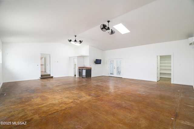 3737 E Pima St, Tucson, AZ 85716 - unfurnished living room with concrete flooring, french doors, baseboards, and vaulted ceiling