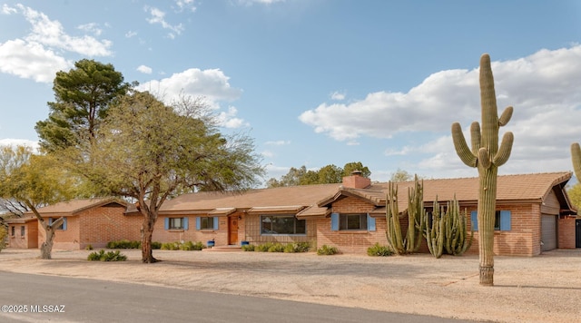 6341 E Brian Kent St, Tucson, AZ 85710 - view of front of house with a chimney and driveway