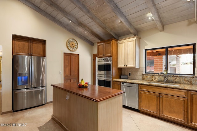 6341 E Brian Kent St, Tucson, AZ 85710 - kitchen with appliances with stainless steel finishes, a kitchen island, beamed ceiling, decorative backsplash, and a sink