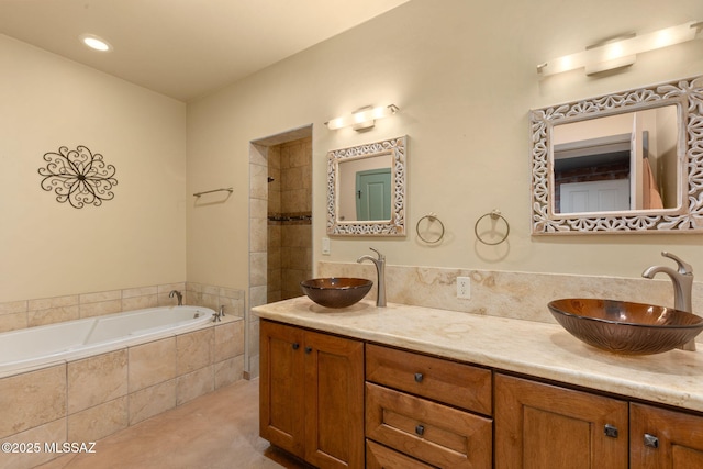 6341 E Brian Kent St, Tucson, AZ 85710 - bathroom featuring double vanity, a sink, and a relaxing tiled tub