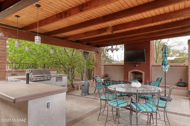 6341 E Brian Kent St, Tucson, AZ 85710 - view of patio featuring an outdoor brick fireplace, a sink, fence, exterior kitchen, and outdoor dining space