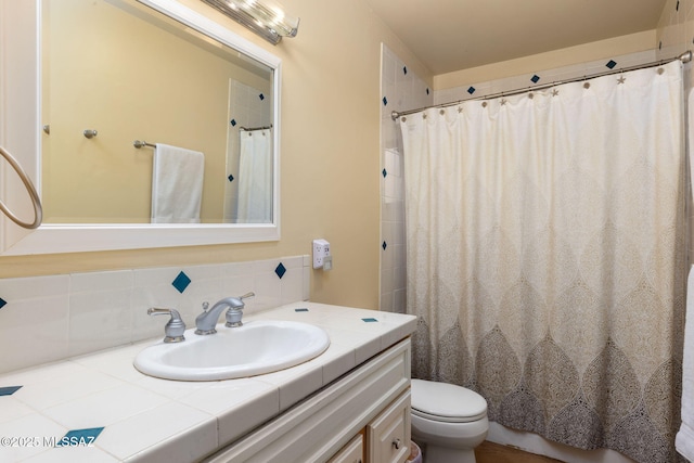 6341 E Brian Kent St, Tucson, AZ 85710 - full bathroom with toilet, decorative backsplash, vanity, and a shower with curtain