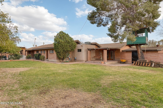 6341 E Brian Kent St, Tucson, AZ 85710 - rear view of house with a patio and a lawn