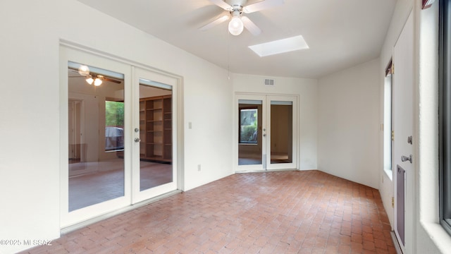 unfurnished living room featuring a notable chandelier, a fireplace, light wood-style floors, visible vents, and arched walkways