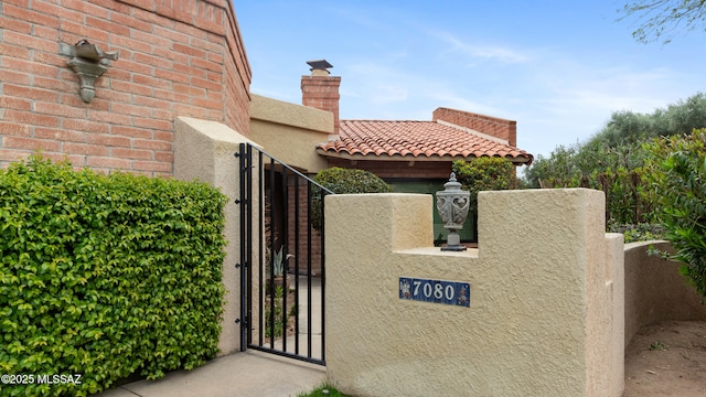 view of gate with fence