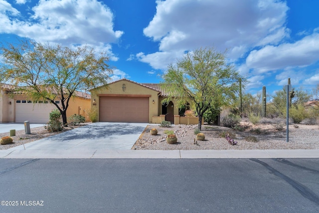 12171 N Golden Mirror Dr, Marana, AZ 85658 - mediterranean / spanish-style home featuring a garage, stucco siding, concrete driveway, and a tile roof