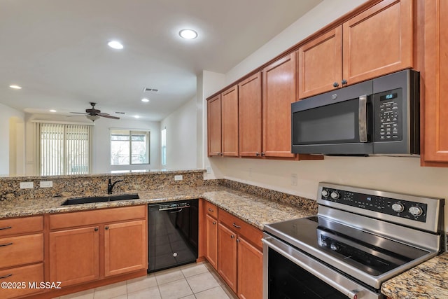 12171 N Golden Mirror Dr, Marana, AZ 85658 - kitchen with stainless steel electric range, dishwasher, a sink, brown cabinetry, and recessed lighting