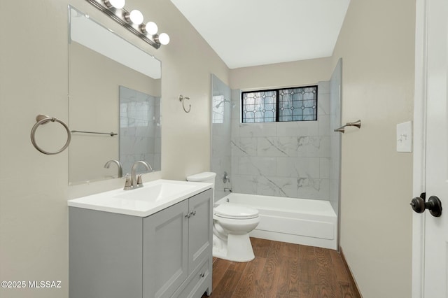 bathroom with toilet, vanity, and wood finished floors