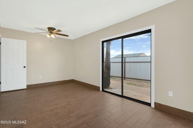 spare room featuring ceiling fan, wood finished floors, and baseboards