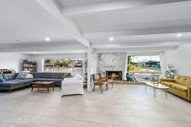 living area featuring recessed lighting, a high end fireplace, beam ceiling, and plenty of natural light