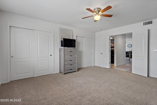 761 W Grantham St, Vail, AZ 85641 - unfurnished bedroom featuring baseboards, light carpet, visible vents, and two closets