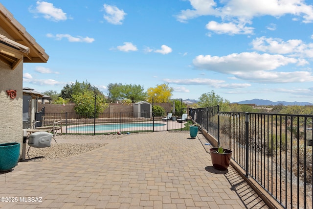 761 W Grantham St, Vail, AZ 85641 - view of swimming pool with an outbuilding, a fenced in pool, a mountain view, a fenced backyard, and a storage unit