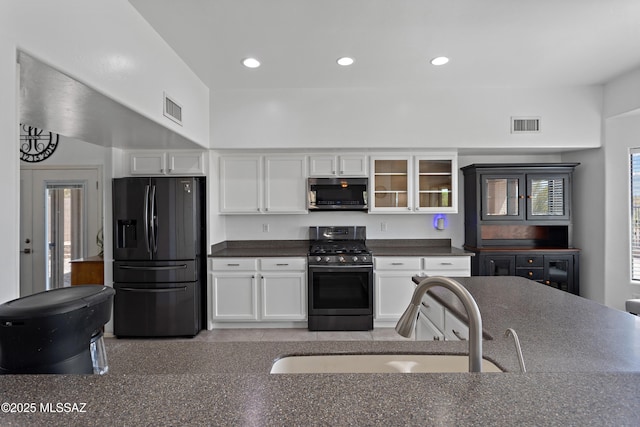 761 W Grantham St, Vail, AZ 85641 - kitchen with a sink, dark countertops, white cabinets, visible vents, and appliances with stainless steel finishes