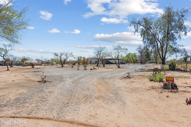 view of street with a rural view and driveway