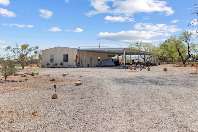view of front of property featuring a carport and gravel driveway